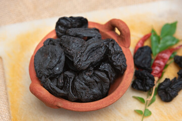 Garcinia atroviridis or Garcinia Cambogia fruit gummi-gutta , Gambooge also called Kudampuli dried. Sun dried Malabar tamarind or brindleberry