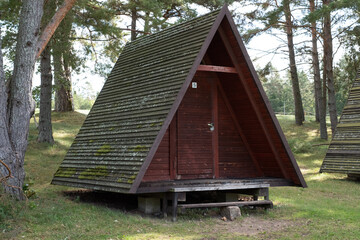 A-frame house or building, triangle shape house. Wooden tent summer house or camping, vacation home. Popular architectural style post–World War II. Wide spread in Estonia during Soviet-era.