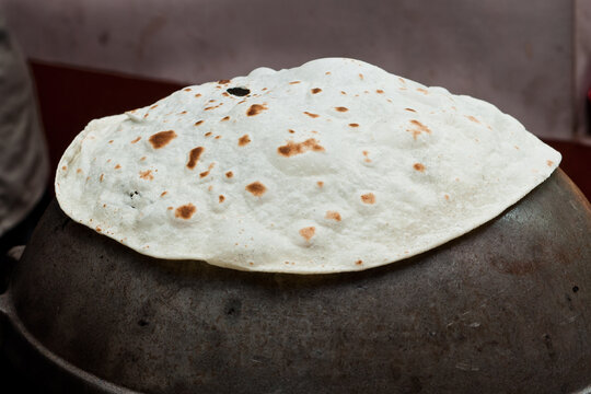 making cooking  Indian flat bread Rumali roti, Lamboo roti made of whole wheat flour or Maida and baked, Jaipur Rajasthan India. chapati, fulka, paratha , roti served with side dish dal curry. 