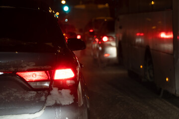 Cars in a winter night traffic jam in the city at night. Selective focus