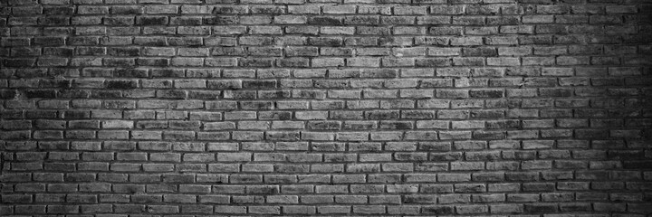 Panorama Abstract dark brick wall texture background pattern, Brickwork painted of black color interior old clean concrete grid uneven, Home or office design backdrop decoration.