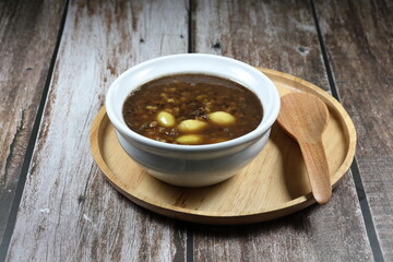 Famous traditional Chinese sweet dessert in the white bowl. Boiled organic mung bean, sago and gingko with sugar syrup. 