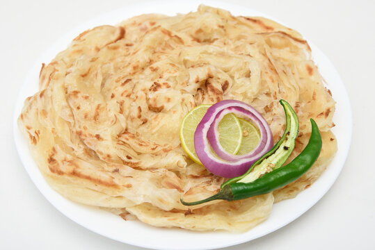 Indian flat bread Kerala porotta, Malabar porotta, paratha layered bread made of whole wheat flour or Maida, India. chapathi, fulka, parantha ,rumali roti served with side dish  meat curry.
