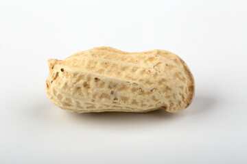 Unpeeled peanut isolated on white