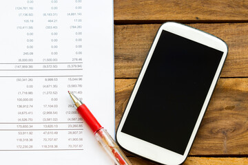 financial statement for check with mobile phone for business work of personal arrangement flat lay style at office desk