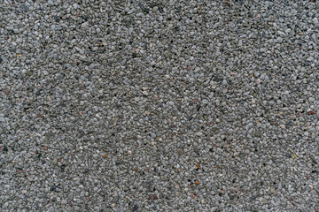 The background. Small stones on the concrete surface