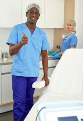 Fototapeta premium Man dermatologist standing in salon of esthetic cosmetology, female on background