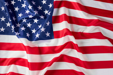 Obraz premium Close up of ruffled American flag. Satin texture curved flag of USA. Memorial Day or 4th of July. Banner, freedom concept