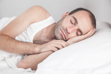 Fototapeta na wymiar Caucasian man sleeping in bed.