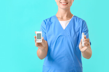 Doctor with digital glucometer and lancet pen on color background. Diabetes concept