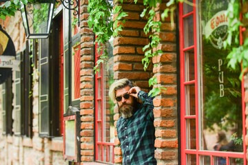 Fototapeta na wymiar Male natural beauty. fashion model wear casual clothes. mature man with beard and moustache. male barbershop style. dyed and healthy hair. bearded man hipster relax outdoor. brutal male at brick wall