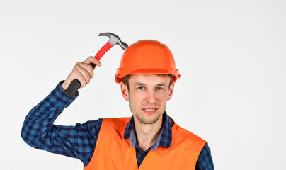 man builder use hammer. professional repairman in helmet. build and construction. skilled architect repair and fix. engineer worker career. tools for repair. young man in hard hat