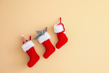 Christmas socks hanging on color wall