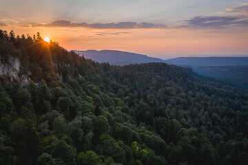 Sunset over the coniferous forest. Lagonaki plateau, Caucasus, Russia