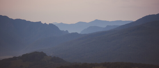 Early morning one hour before dawn. Silhouettes of mountains in the morning haze. Lagonaki Plateau, Republic of Adygea, Russia