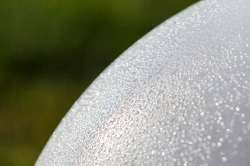 Texture of dew drops on a white ball.