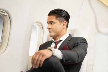 portrait of a businessman on flight alone traveler. Business men and seated passengers ready to leave There is a flight attendant service.