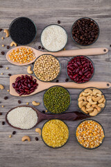 Cereal grains seeds beans on wooden background. Whole grains and bean. Cereals and beans. Different dry legumes for eating healthy
