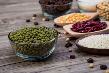 Organic mung beans on wooden table. Green beans, Dried mung beans. Vegan raw ingredients organic farm fresh green beans
