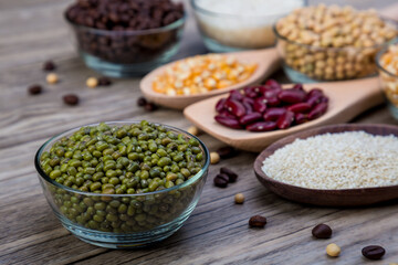 Organic mung beans on wooden table. Green beans, Dried mung beans. Vegan raw ingredients organic farm fresh green beans