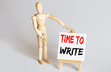 Wooden man shows with a hand to white easel with text TIME TO WRITE on white background