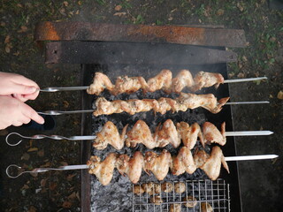 meat on the grill and hands