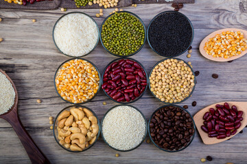 Cereal grains seeds beans on wooden background. Whole grains and bean. Cereals and beans. Different dry legumes for eating healthy