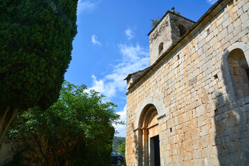 Fototapeta na wymiar ROCABRUNA, CATALONIA, SPAIN, EUROPE, SEPTEMBER 2020. Exterior of the 12th century Romanesque church in the medieval town of Rocabruna.