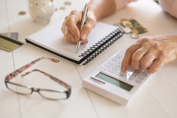 Old women's hands count expenses, plan a budget the concept of retirement, savings, old age.