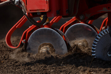 Sowing machine close up. Seeding crop with dry fertilizer. Disc coulters.