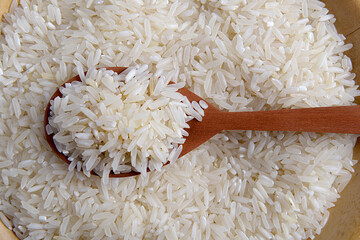 Uncooked rice in a spoon