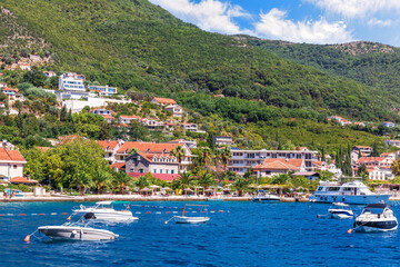 Fototapeta premium Boats by the coast of the Adriatic sea in the Bay of Kotor, Montenegro