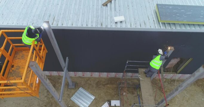 Welder at work, metal welding process. Welders at a construction site