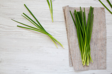 Raw Green Onions on a white wooden background, top view. Flat lay, overhead, from above. Copy space.
