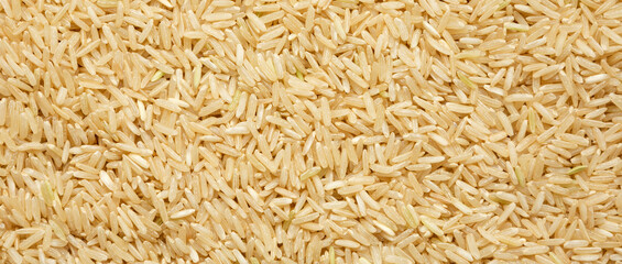 Dry Brown Rice background, view from above. Overhead, top view, flat lay.