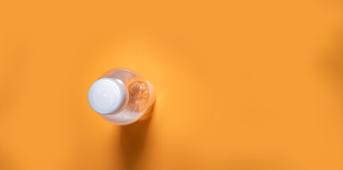 water bottle on orange background with copy space. Simplicity