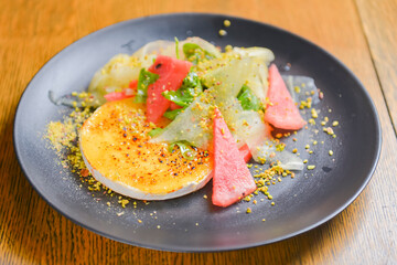 Watermelon and cucumber cheese salad with mint and melon. Watermelon summer menu, seasonal meal concept.