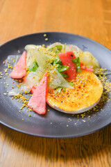 Watermelon and cucumber cheese salad with mint and melon. Watermelon summer menu, seasonal meal concept.