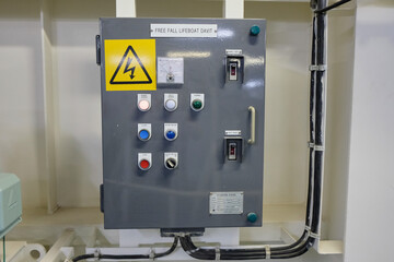 Freefall lifeboat davit control panel with high voltage sign on bulk carrier