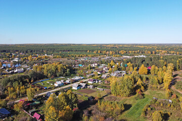 Autumn top view of the autumn forest and a small apiary on its edge
