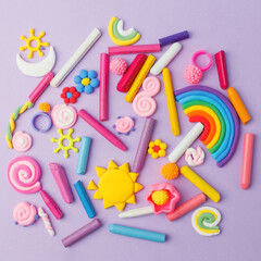 Abstract purple pastel background with many kids accessories from clay, wax chalk, Concept of pop art culture, 80s, 90s, creative design, nen plastic bold color experimental idea