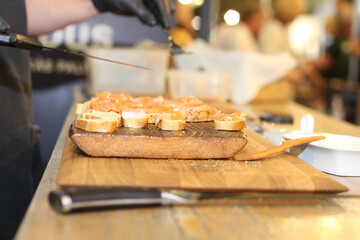 Bread and fish. Man cutting fish and bread. Kitchen. Market. Restaurant. 