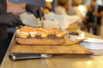 Bread and fish. Man cutting fish and bread. Kitchen. Market. Restaurant. 
