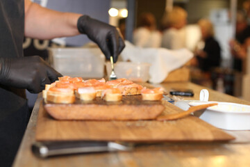 Bread and fish. Man cutting fish and bread. Kitchen. Market. Restaurant. 