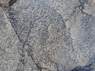 Natural background of rock in riverside india.  Stones texture and background. Rock texture. Rock fragment. Abstract background. A fragment of rock. 