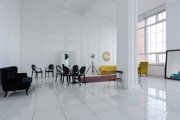 modern fashionable futuristic interior design of a spacious white hall with black and yellow furniture