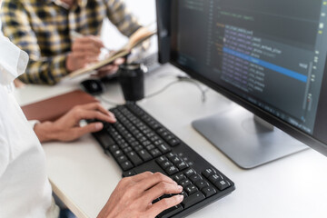 Programmer team coding data software at IT company.