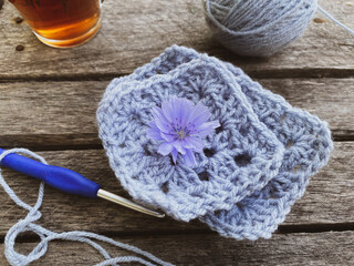 knitted fragments with flowers and cup of tea