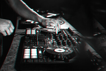 DJ mixes music on a professional controller Board in a nightclub at a party