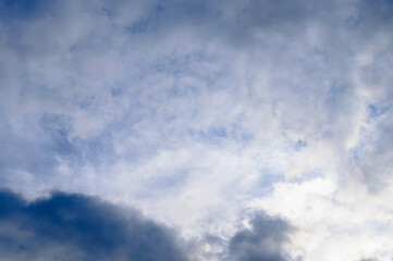 Naklejka na ściany i meble Abstract background of white fluffy clouds on a bright blue sky